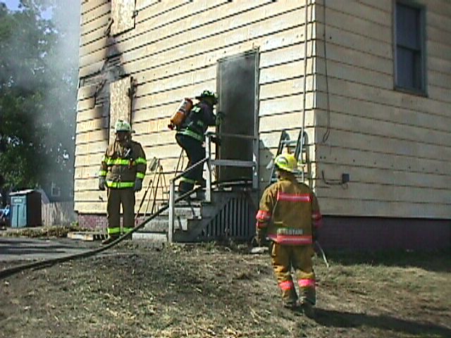Firefighter entering a building during a Class A fire attack training exercise